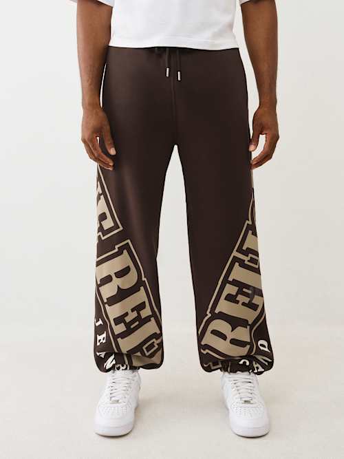 МЕШКОВАТЫЙ ДЖОГГЕР С АРОЧНЫМ ЛОГОТИПОМ ДЛЯ БЕГА ТРУСЦОЙ