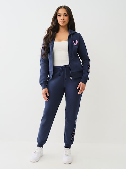 PANTALONES JOGGER CON LOGOTIPO DE CRISTAL