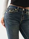 JEANS JENNIE SKINNY CURVILÍNEOS DE TIRO MEDIO BIG T