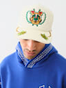 EMBROIDERED CREST TRUCKER HAT
