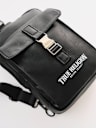 METAL CLASP LOGO SLING BAG