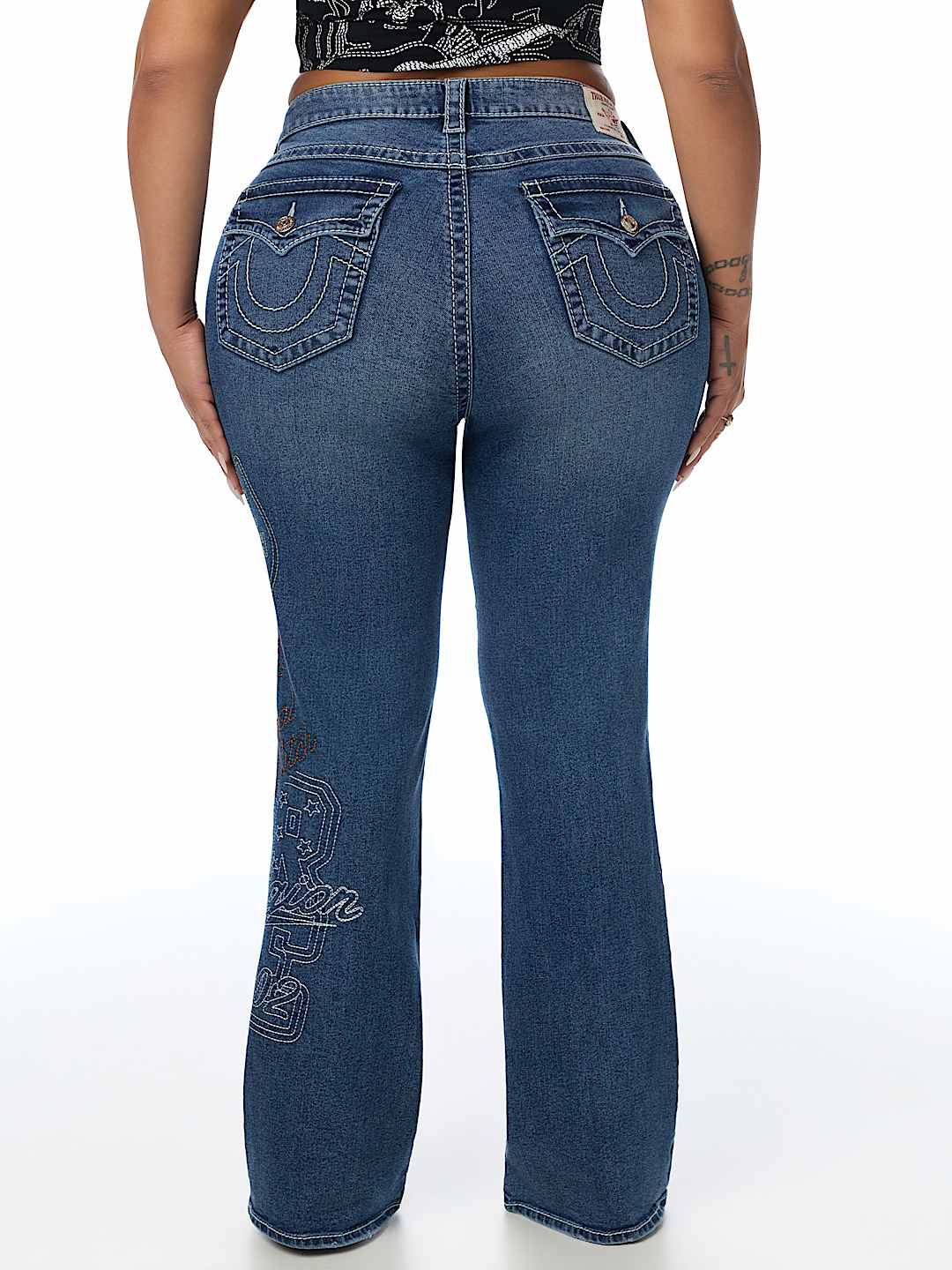 PLUS BECCA MID RISE EMBROIDERED BIG T FLAP BOOTCUT JEAN