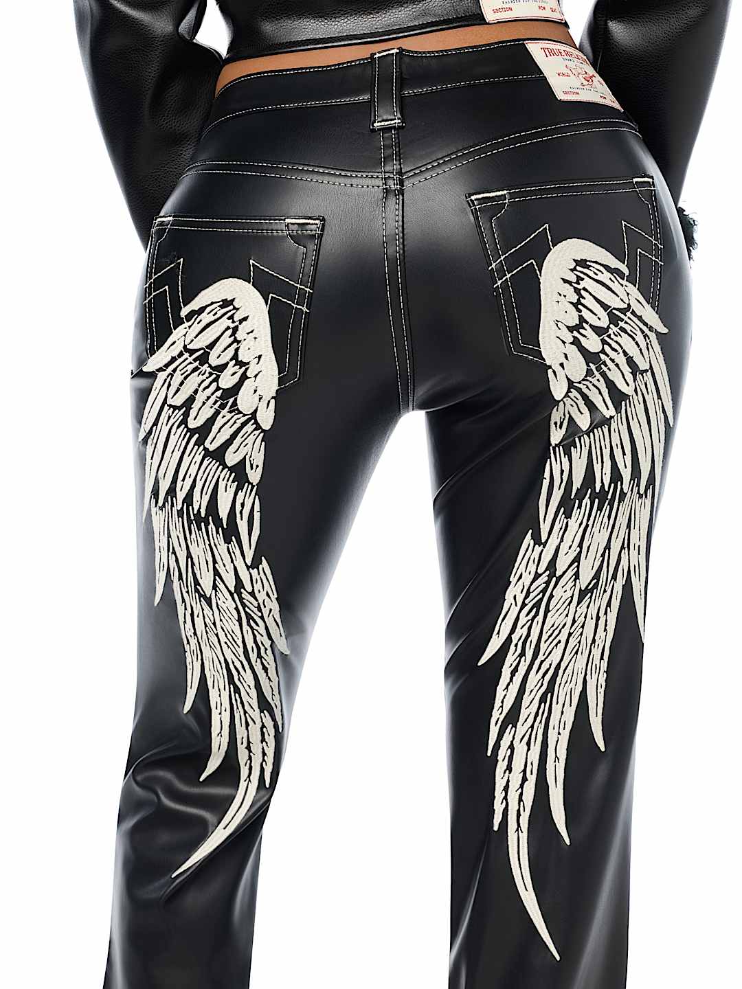 BECCA MID RISE EMBROIDERED WING FAUX LEATHER BOOTCUT JEAN