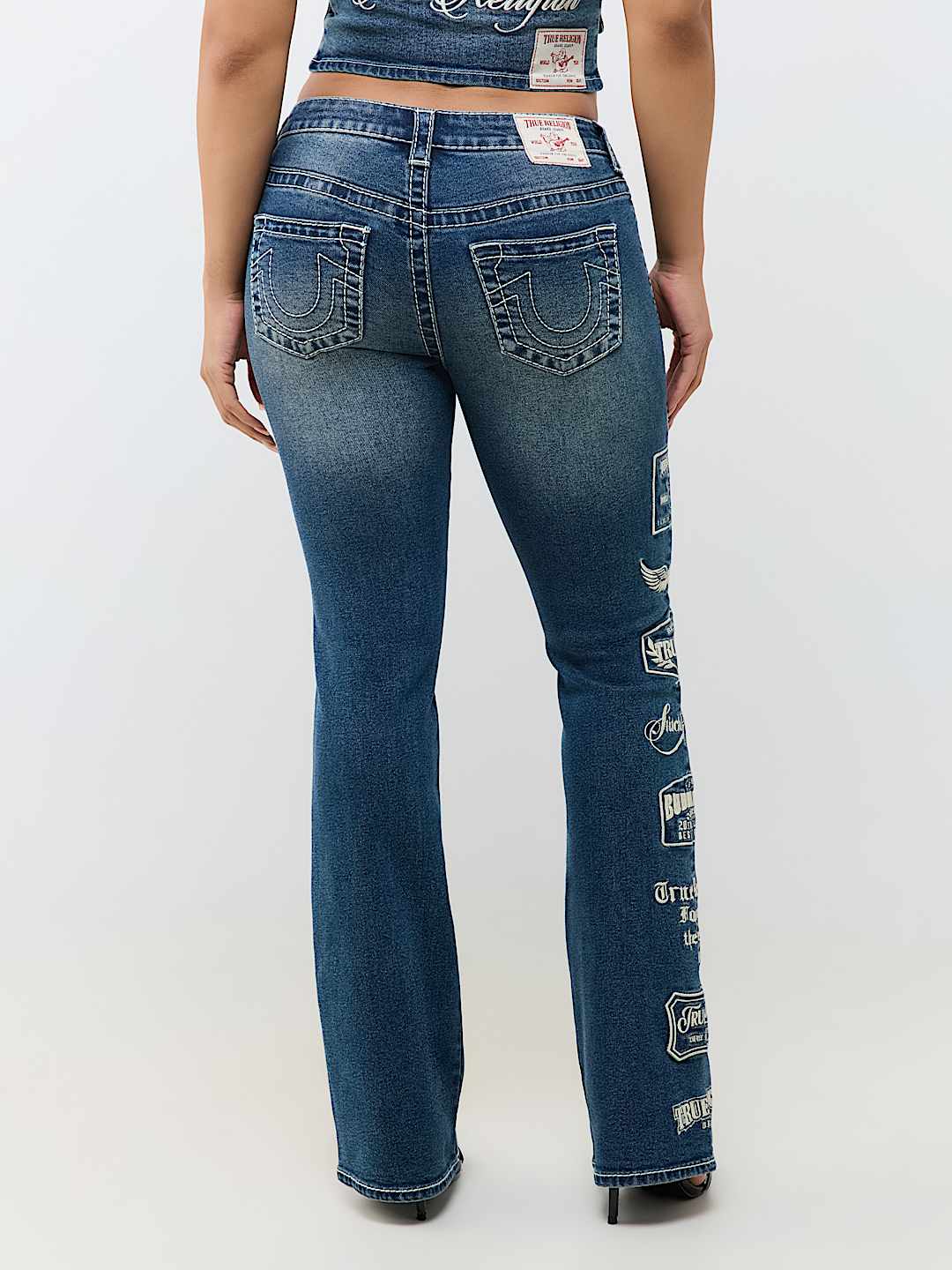 BECCA MID RISE EMBROIDERED LOGO BIG T BOOTCUT JEAN