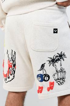 SHORT EN MOLLETON AVEC LOGOS DESSIN&Eacute;S