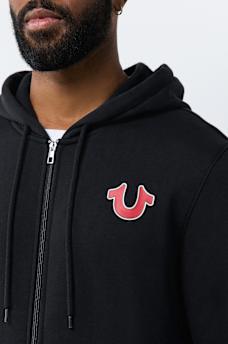 SUDADERA CON CAPUCHA Y CIERRE CON LETRERO DE TRUE