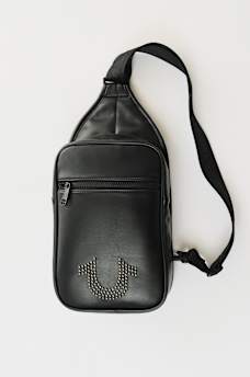 STUDDED HORSESHOE SLING BAG, image 1